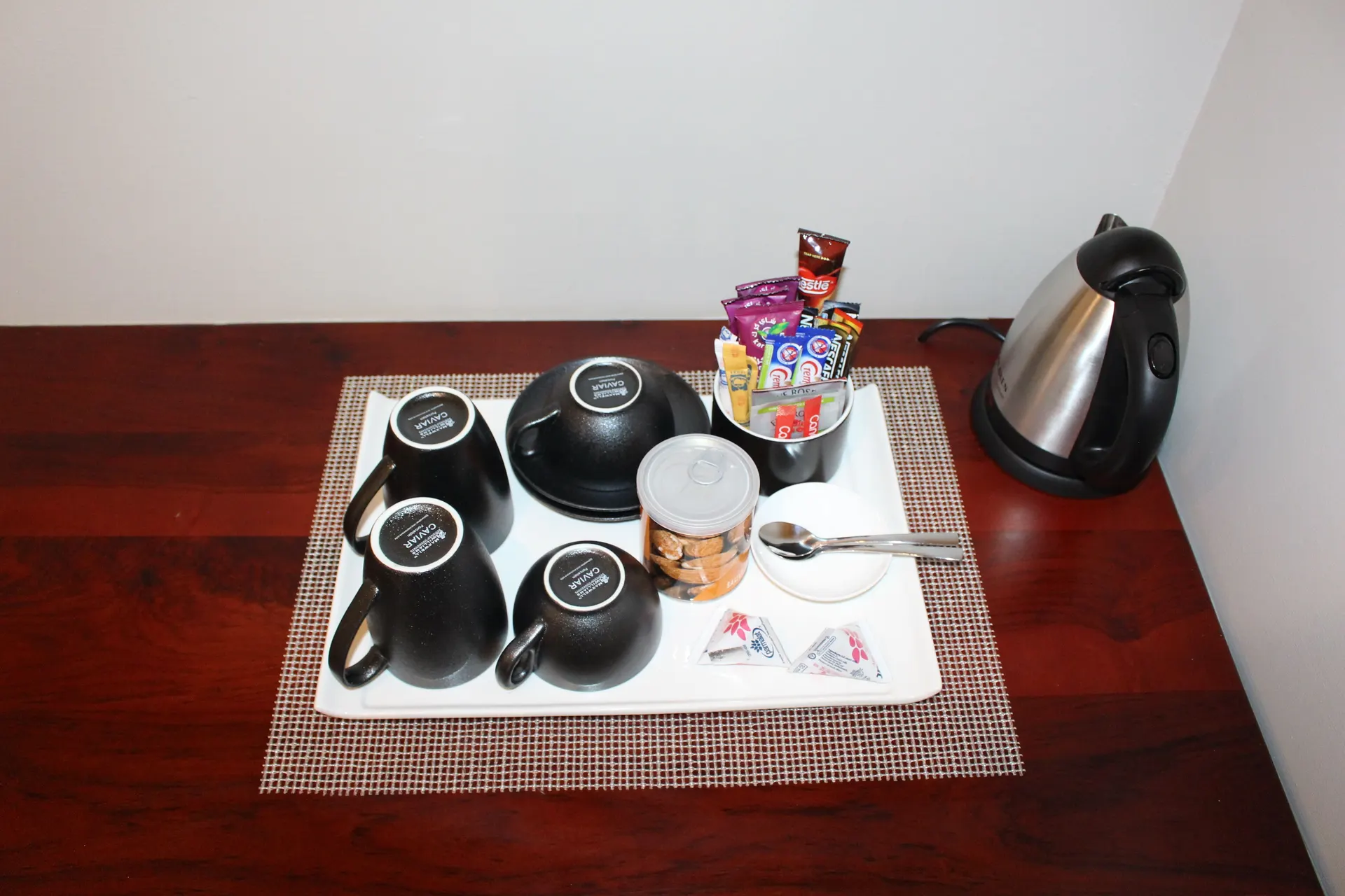 In-room tea and coffee tray with kettle, cups and snacks at FIRN Lodge