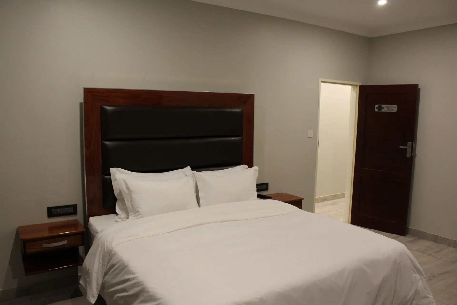 Executive Room at FIRN Lodge with a king bed, floating bedside drawers and the room's entry door
