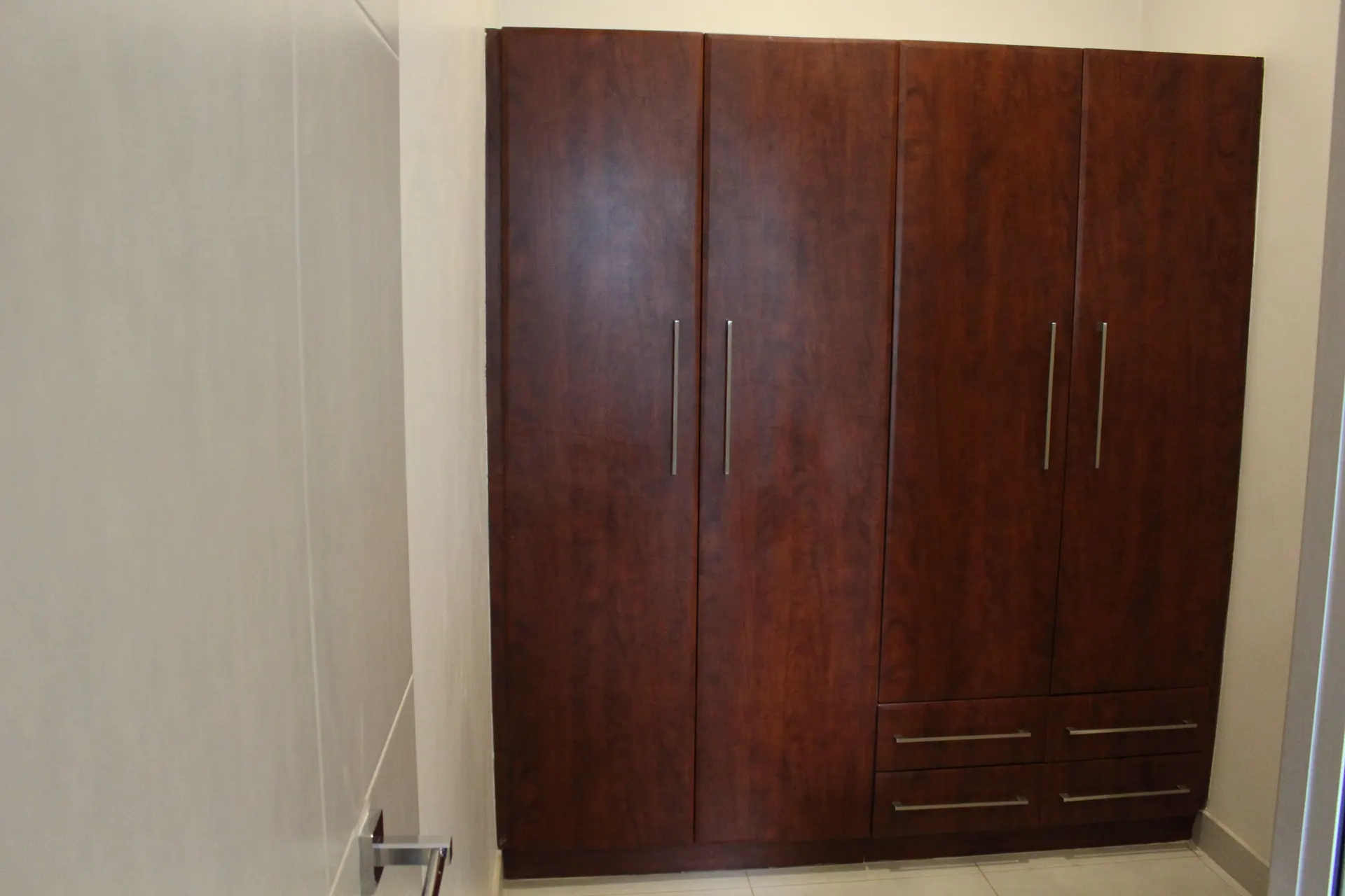 Large four-door wardrobe in the Executive Room's separate dressing area at FIRN Lodge