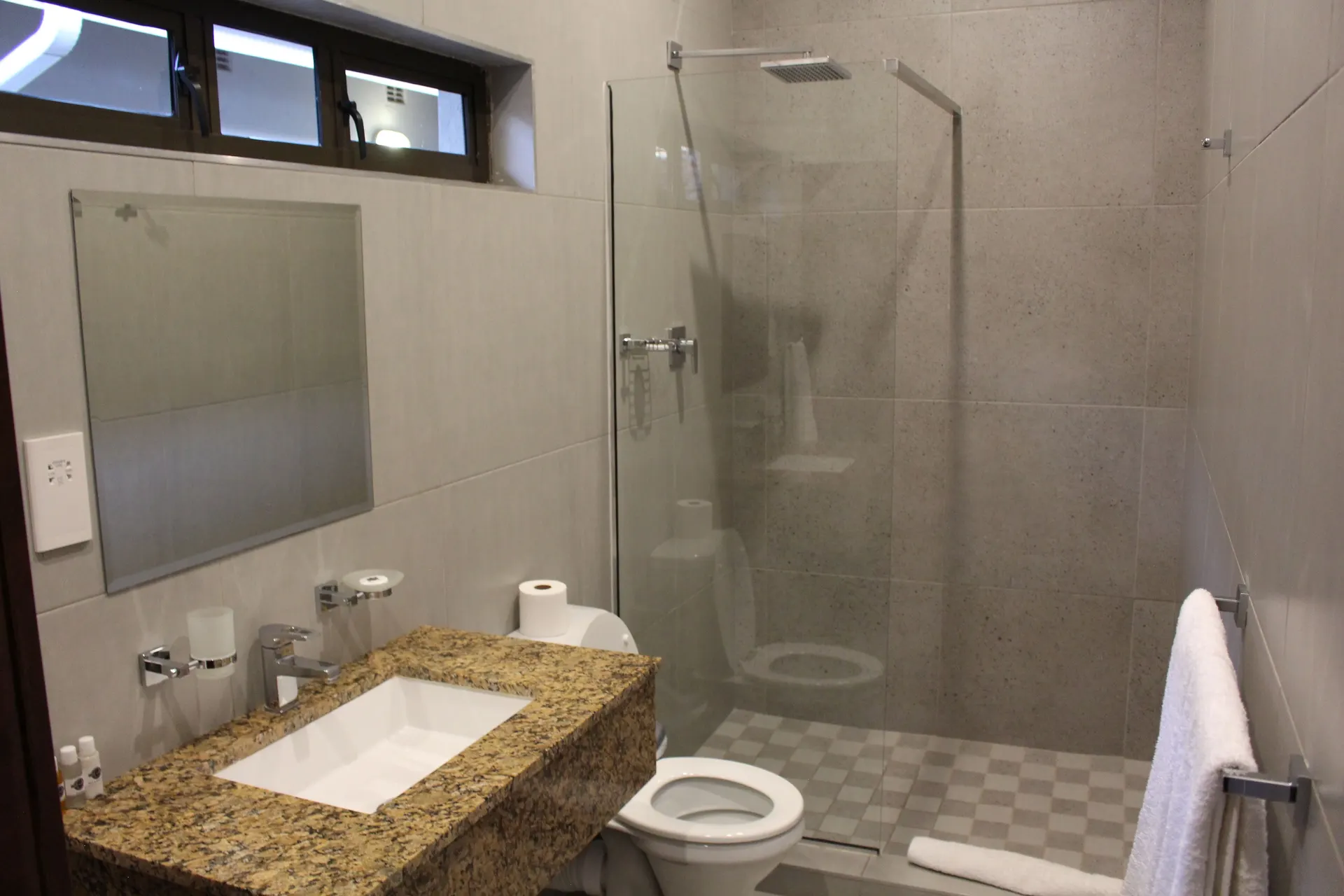 En-suite shower room with a walk-in rain shower and granite vanity