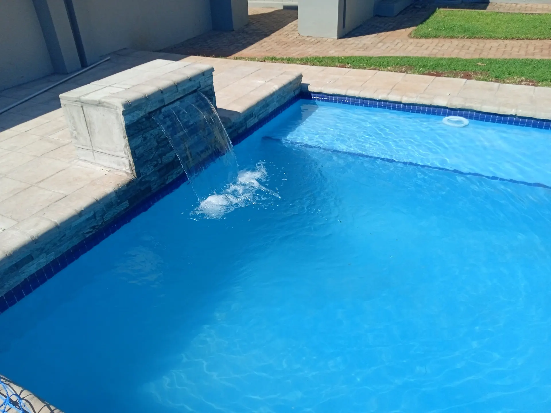 The pool and its stone water feature at FIRN Lodge