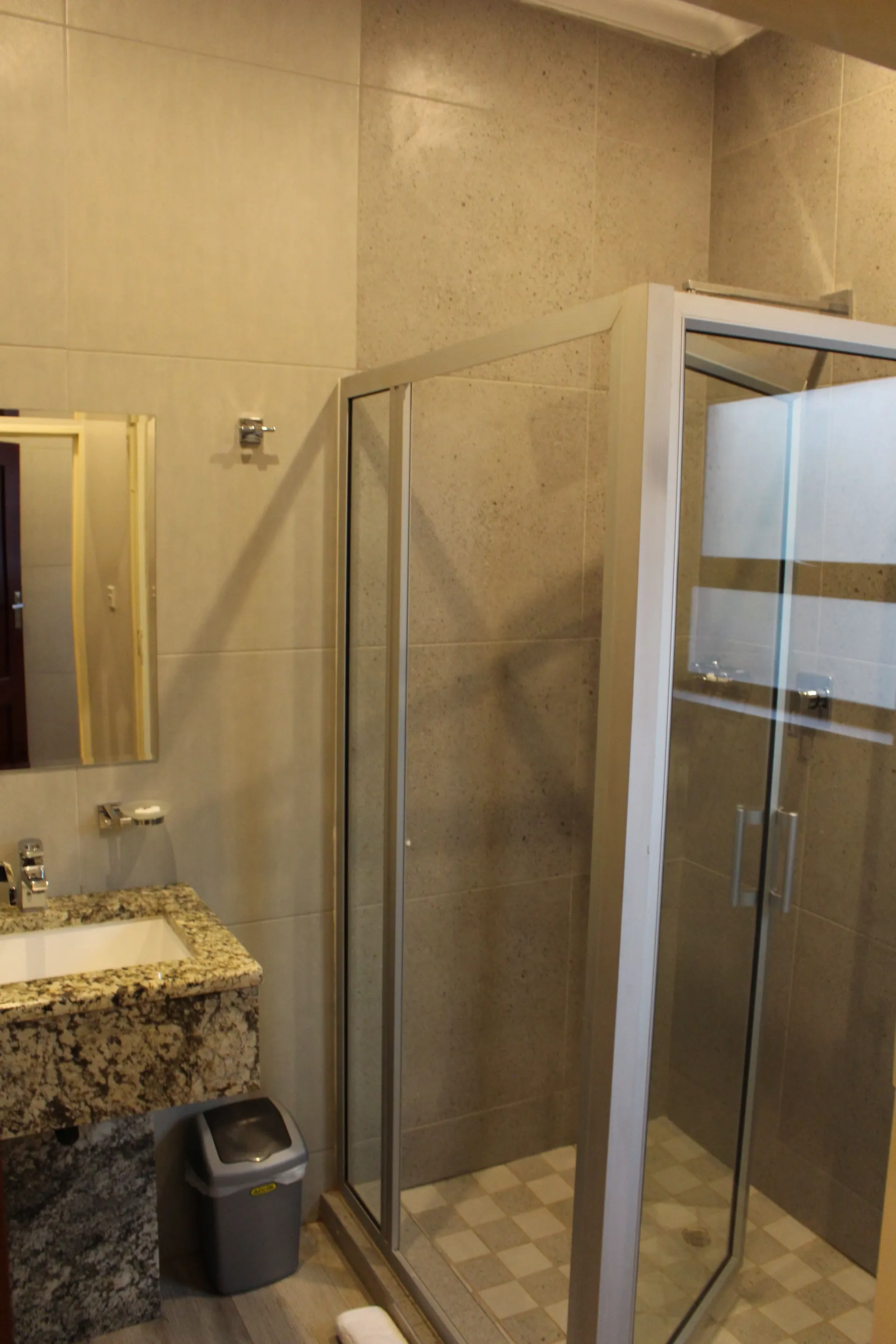 En-suite bathroom of the Poolside Twin Room at FIRN Lodge with a glass corner shower